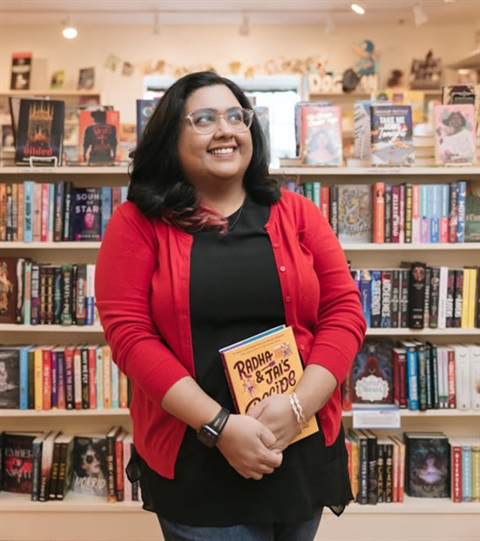 picture of nisha sharma holding her book