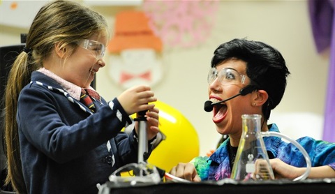 a child assisting a woman with a science experiment.jpg